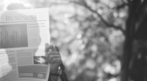 man reading business section of newspaper