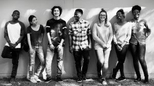 line of young people leaning against wall