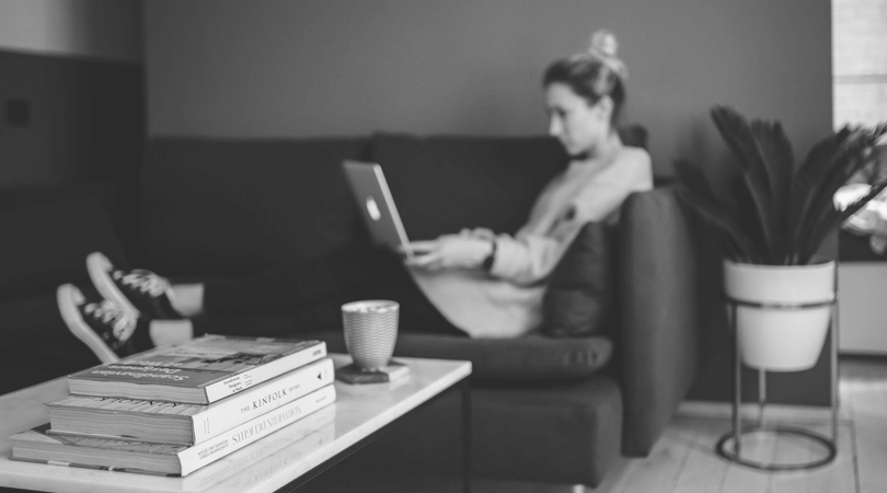 woman sitting on couch on laptop
